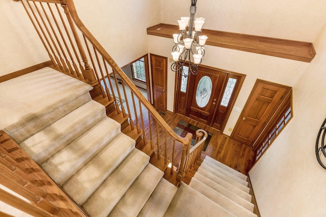 foyer featuring wood-type flooring and a high ceiling