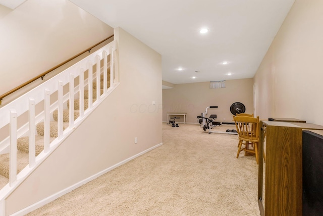 exercise area featuring light colored carpet