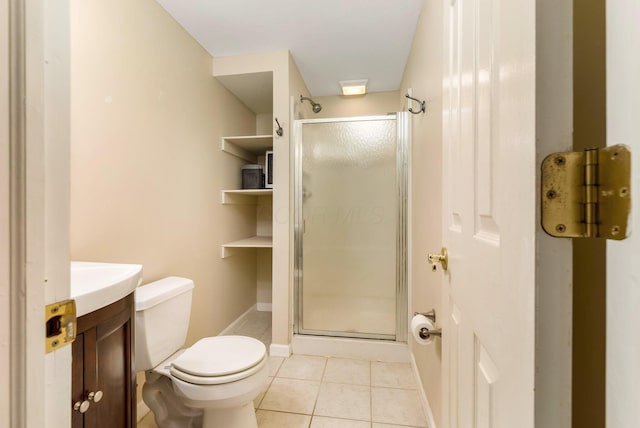 bathroom featuring walk in shower, vanity, tile patterned floors, and toilet