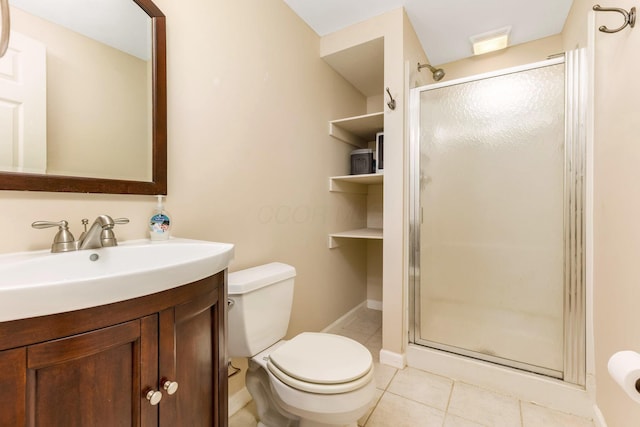 bathroom with vanity, toilet, a shower with shower door, and tile patterned flooring