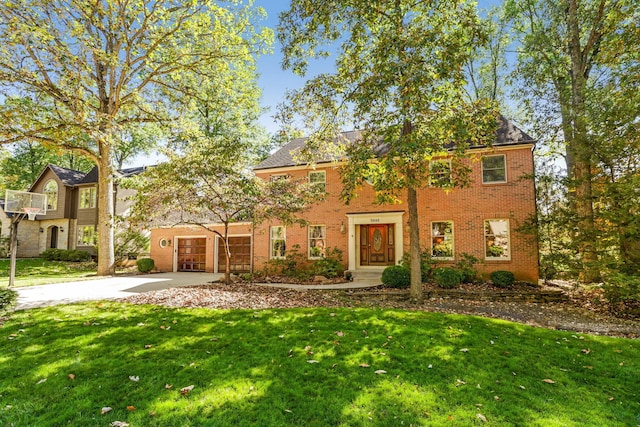 view of front facade with a garage and a front lawn