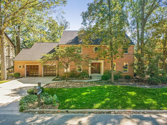 5640 Morlich Sq, Dublin, OH 43017 - view of front of house with concrete driveway, a garage, a front lawn, brick siding, and roof with shingles