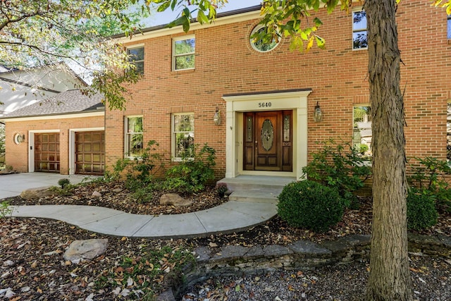 5640 Morlich Sq, Dublin, OH 43017 - view of exterior entry featuring driveway, an attached garage, and brick siding