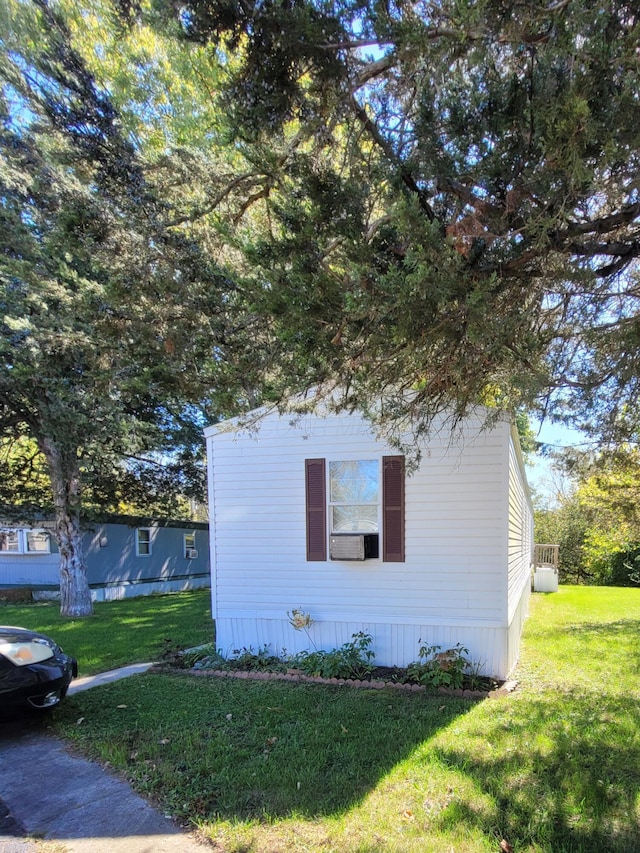 view of side of home featuring a lawn