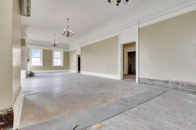 unfurnished room featuring ornamental molding and a notable chandelier