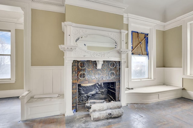 bathroom with ornamental molding, plenty of natural light, and a fireplace