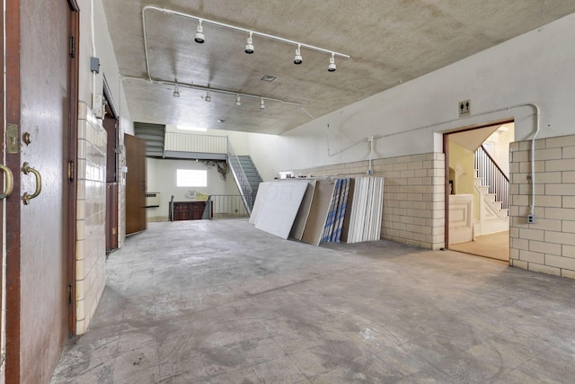 interior space featuring track lighting and concrete flooring