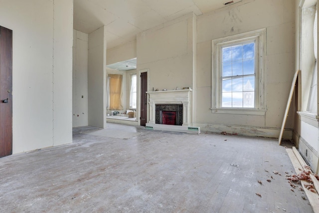 unfurnished living room featuring a high end fireplace