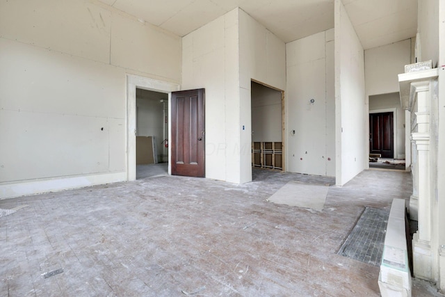 spare room featuring a towering ceiling