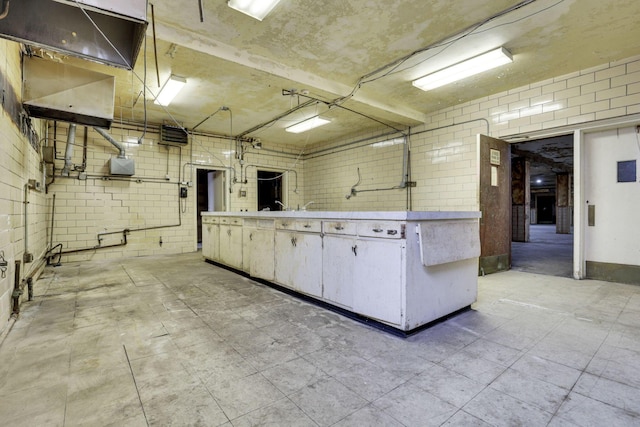 kitchen featuring brick wall