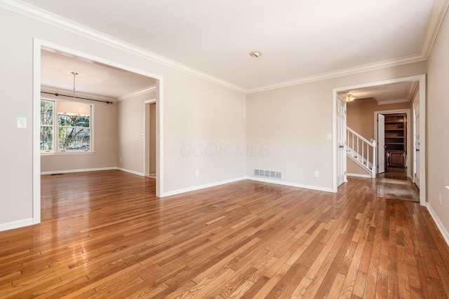 unfurnished room with hardwood / wood-style flooring and crown molding