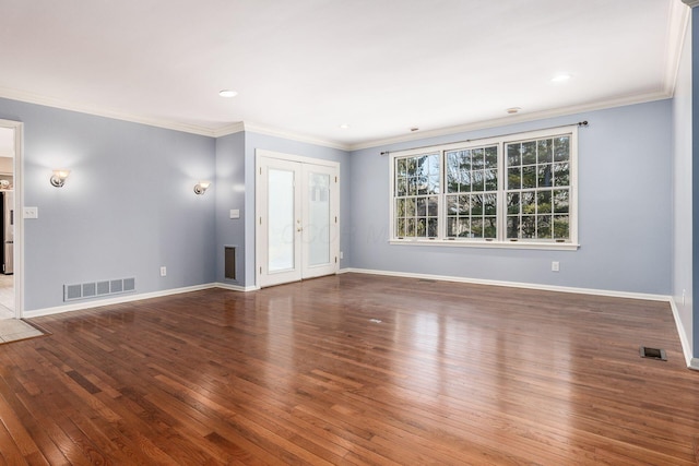 empty room featuring crown molding and wood-type flooring