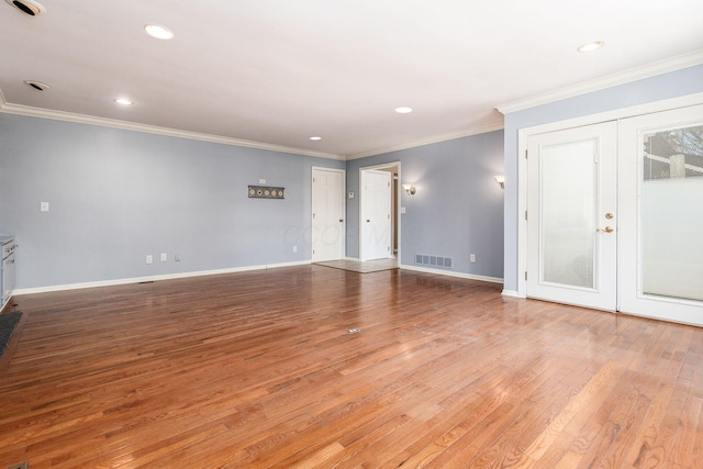 empty room with crown molding, hardwood / wood-style flooring, and french doors