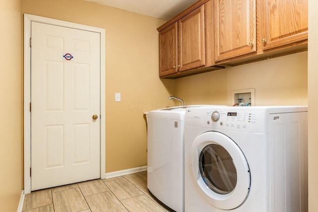 laundry area with cabinets and washing machine and clothes dryer