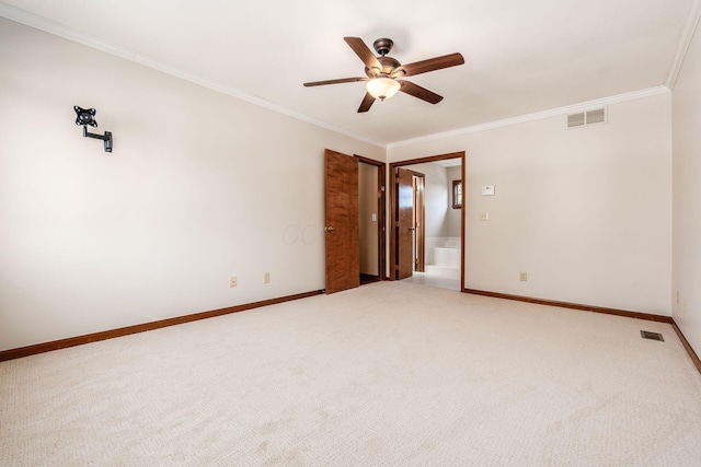 spare room with carpet floors, ornamental molding, and ceiling fan