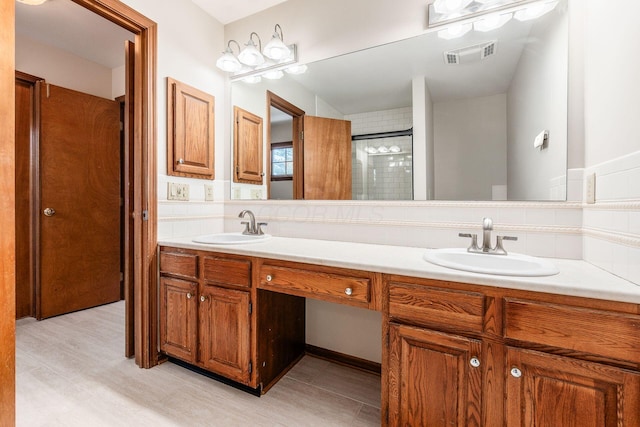 bathroom with tasteful backsplash, vanity, and a tile shower