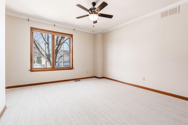 carpeted spare room with crown molding and ceiling fan