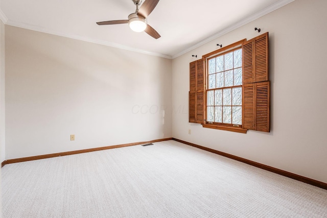 spare room with ornamental molding, carpet, and ceiling fan