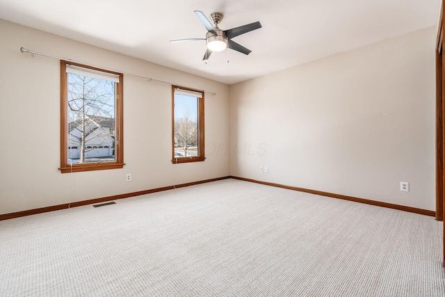 empty room with ceiling fan and carpet flooring