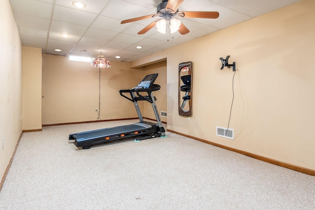 exercise area with carpet floors, a drop ceiling, and ceiling fan