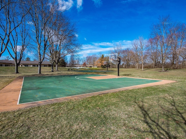 view of basketball court with a lawn