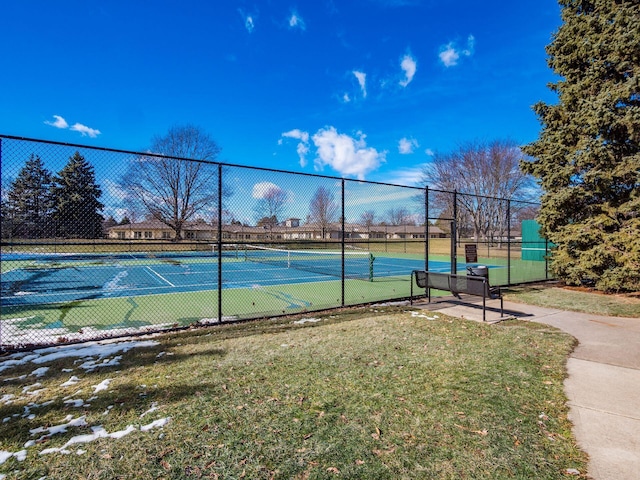 view of sport court with a lawn