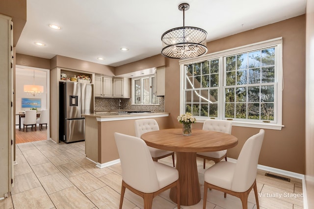 dining area with a wealth of natural light and a chandelier