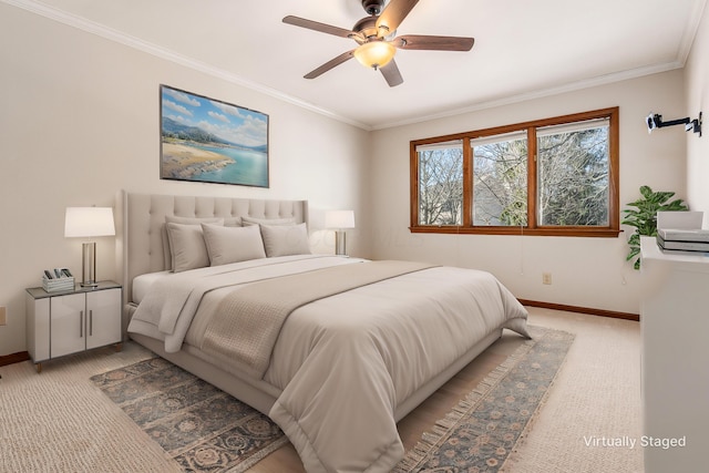 carpeted bedroom with ornamental molding and ceiling fan