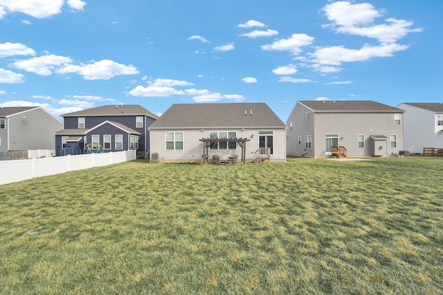 back of house featuring a lawn and a pergola