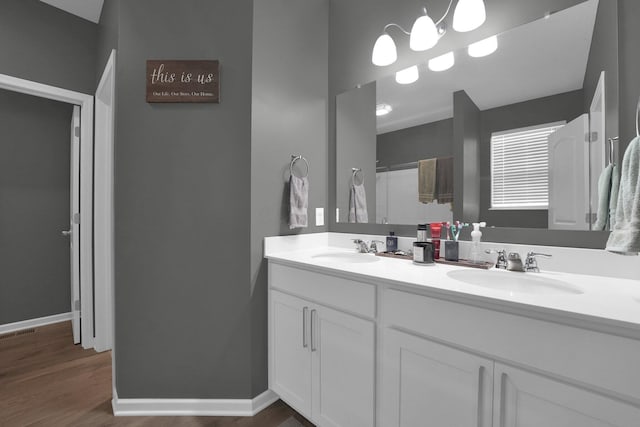 bathroom featuring hardwood / wood-style flooring, vanity, and curtained shower