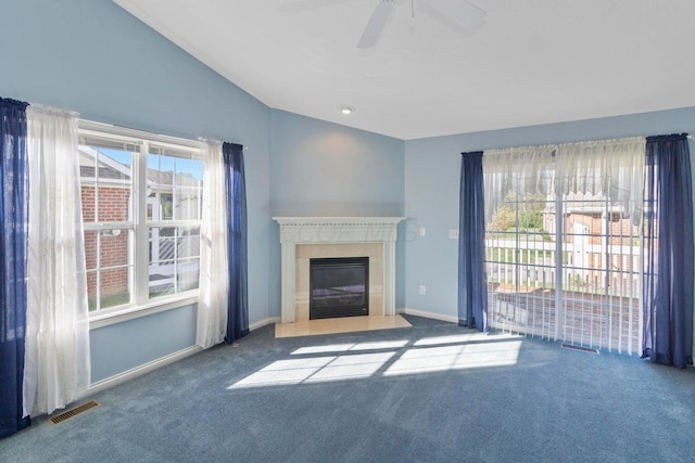 unfurnished living room with vaulted ceiling, ceiling fan, and carpet