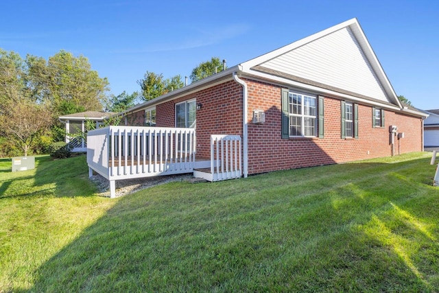 view of home's exterior with a yard and a deck