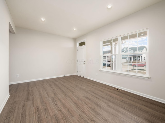 empty room featuring dark wood-type flooring