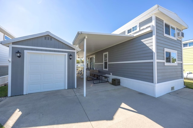 view of side of property with a garage and an outdoor structure