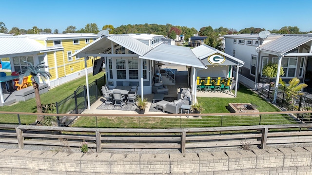 back of house with a bar, an outdoor hangout area, and a patio area