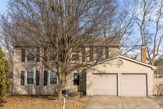 colonial-style house featuring driveway and an attached garage