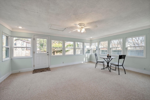 unfurnished sunroom featuring ceiling fan