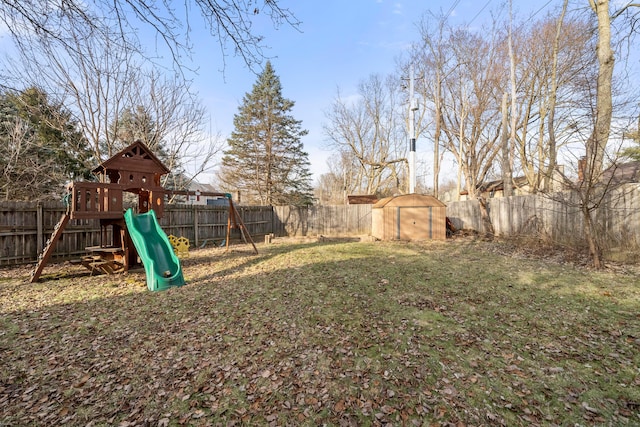 view of yard with a storage unit and a playground