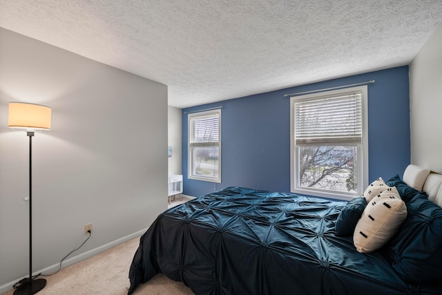 bedroom with light carpet and a textured ceiling