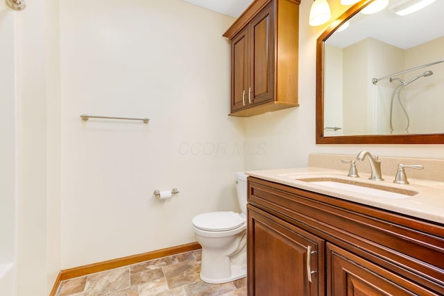 bathroom with a shower, vanity, and toilet