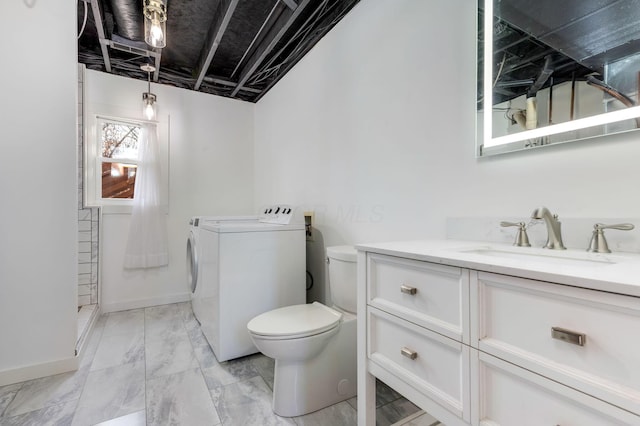 bathroom with vanity, toilet, and separate washer and dryer