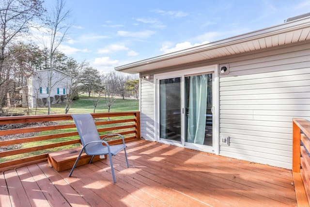 wooden deck with a lawn