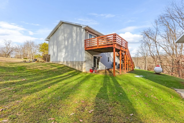 rear view of property featuring a lawn and a deck