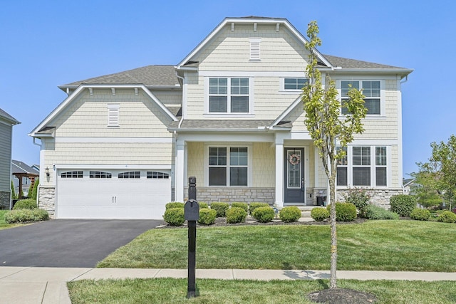 craftsman inspired home featuring a garage and a front yard