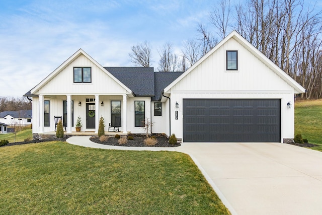 modern inspired farmhouse with a garage, a front lawn, and a porch