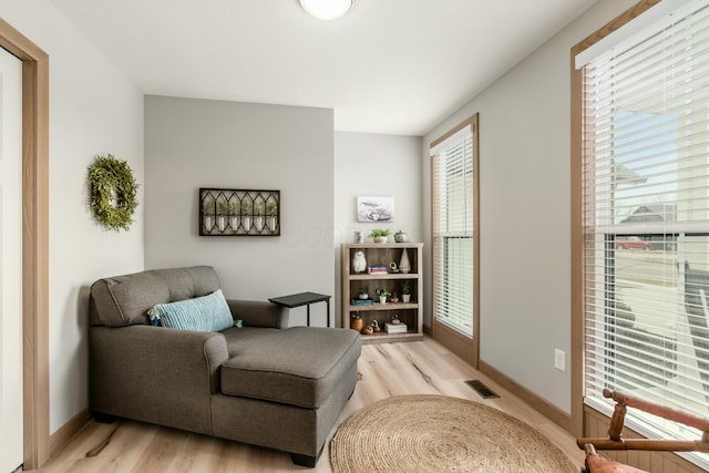 sitting room featuring a healthy amount of sunlight and light hardwood / wood-style flooring