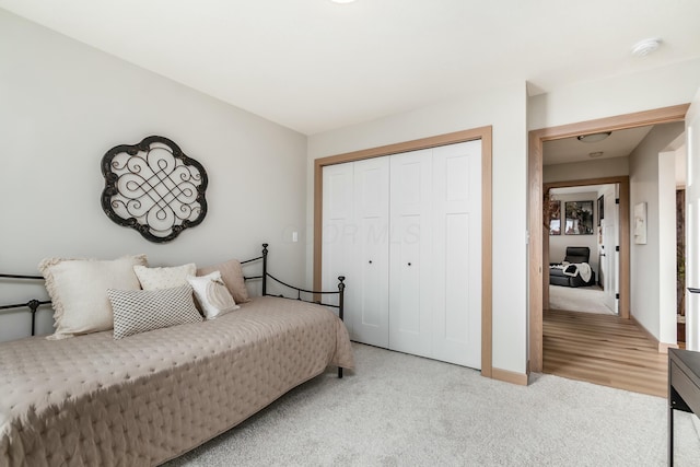 bedroom featuring light carpet and a closet