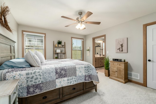 carpeted bedroom with ceiling fan and ensuite bathroom