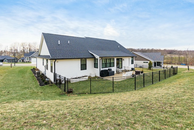 rear view of house featuring cooling unit, a yard, and a patio area