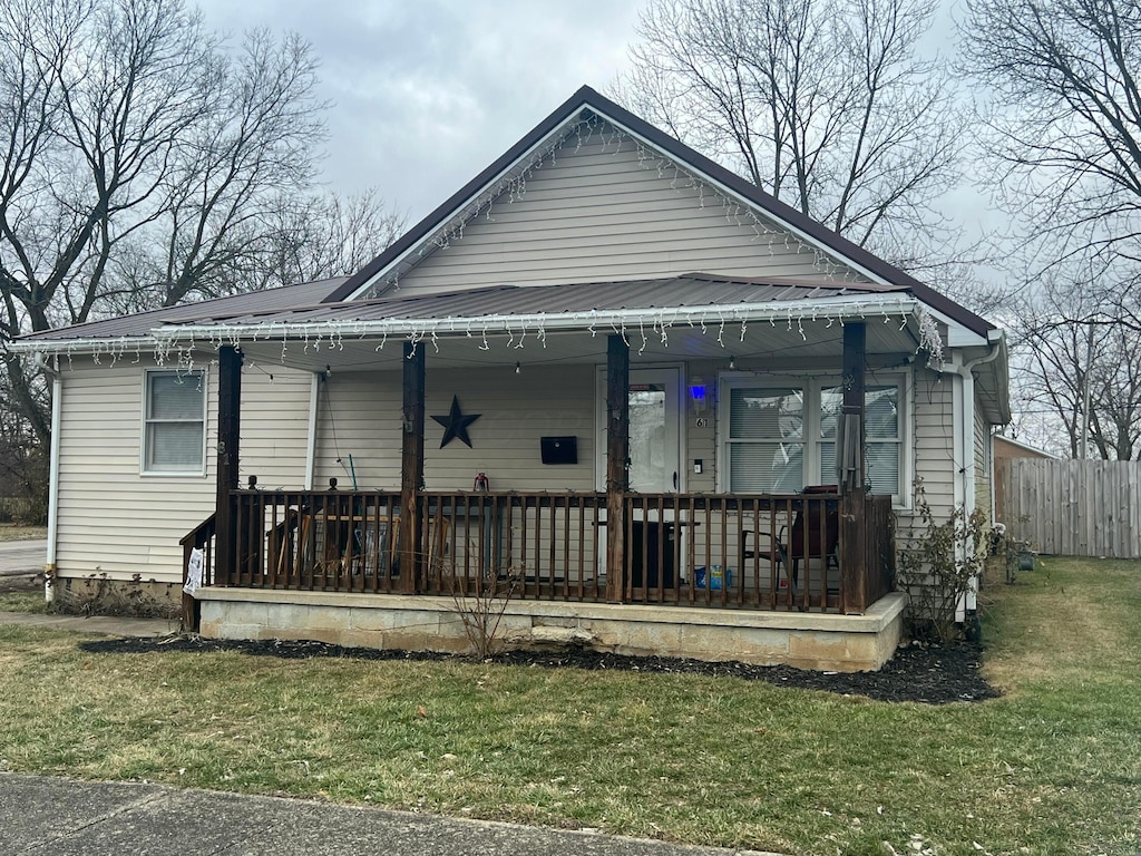 view of front of property with a front yard and a porch